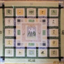 Callas Through Garden Windows - This was an improvisational quilt I made for my daughter\'s wedding. I designed the center calla applique from a floral arrangement in my home. Each block is a peek through a Japanese window.